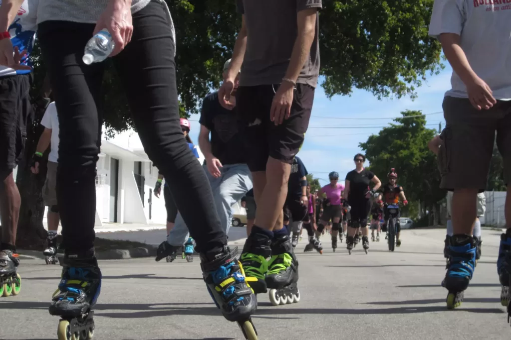A group of inline skaters gliding smoothly along a trail, demonstrating proper etiquette and safety measures.