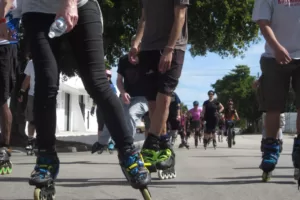 A group of inline skaters gliding smoothly along a trail, demonstrating proper etiquette and safety measures.